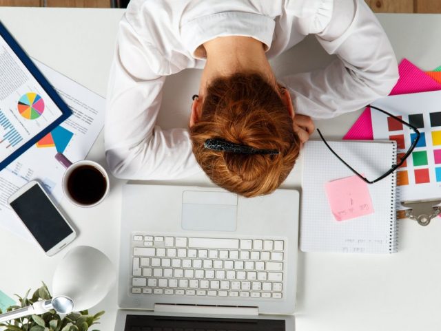 woman-sleeping-at-office-work-desk